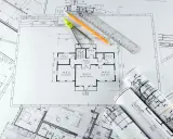 Plans d'architecte, compas, crayon et règle pour savoir comment faire une extension de maison pas chère.