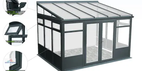 A modern conservatory with a grey aluminium structure and a dark grey muret soubassement. The roof is made of translucent panels.