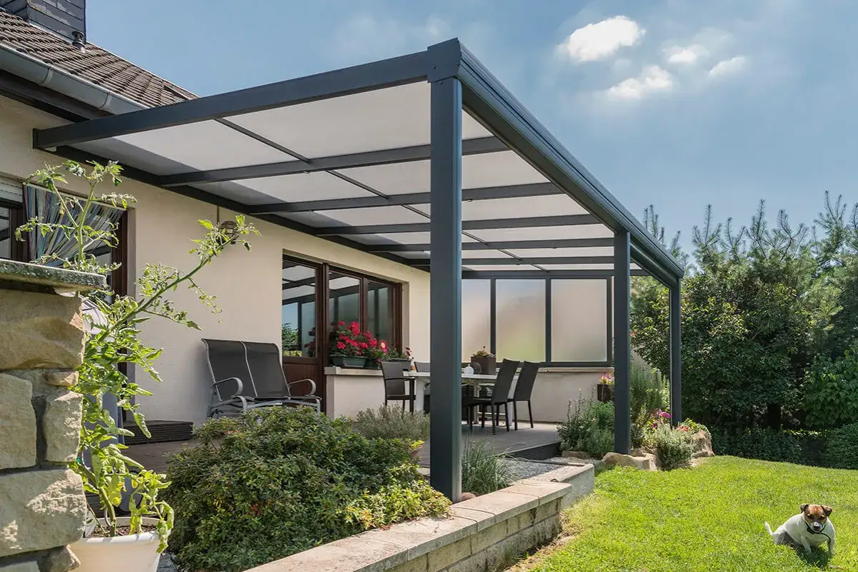Une pergola en polycarbonate moderne prot&egrave;ge une terrasse avec mobilier. Avis positifs sur cette structure &eacute;l&eacute;gante et fonctionnelle.